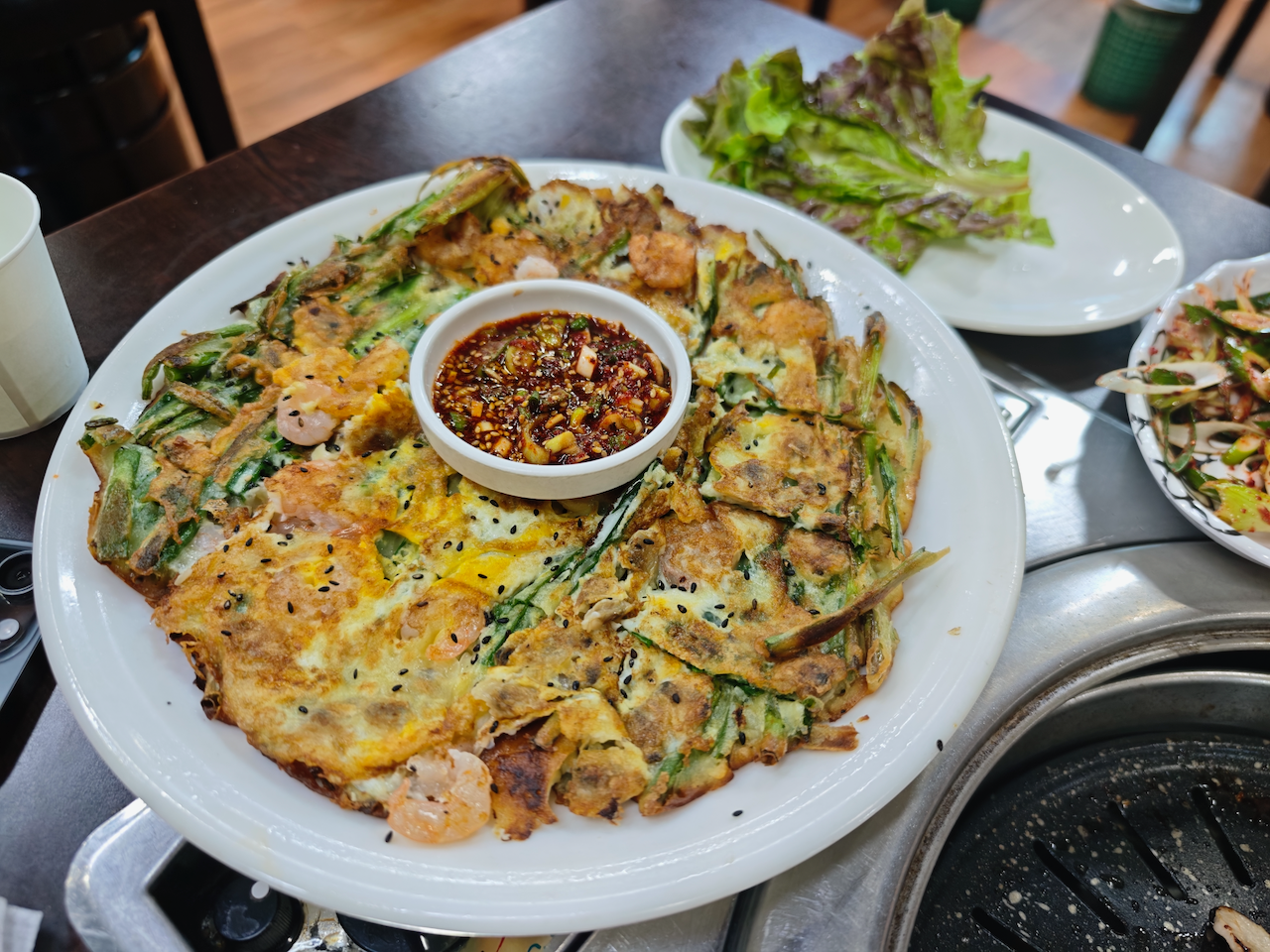 一盘韩式海鲜葱饼，中间是辣酱油碟